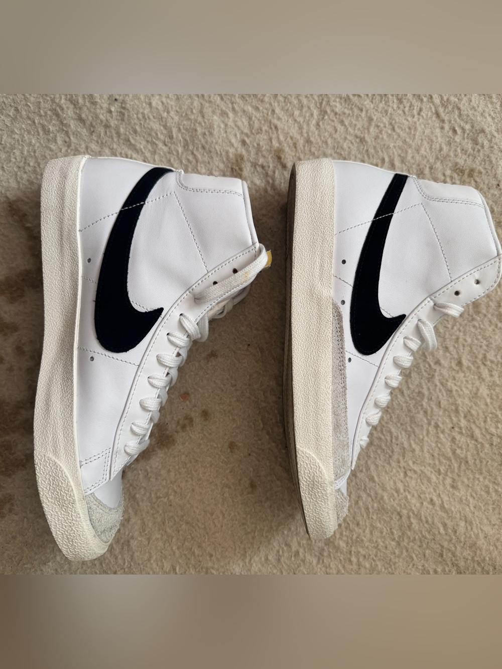 Nike White High-Top Sneakers with Black Swoosh